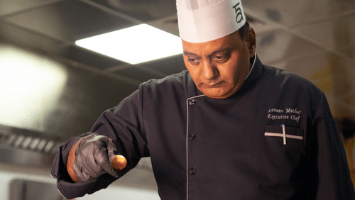 A chef working in a kitchen at Ananta Spa and Resort, Ajabgarh