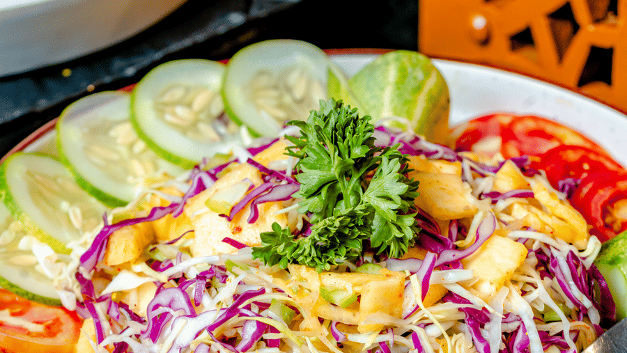 A fresh garden salad with red cabbage and cucumber slices at Marble Arch, located within Noor-Us-Sabah Palace, Bhopal, served on a buffet platter.