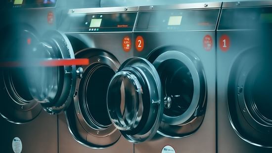 grey coloured Laundry machines with door open
