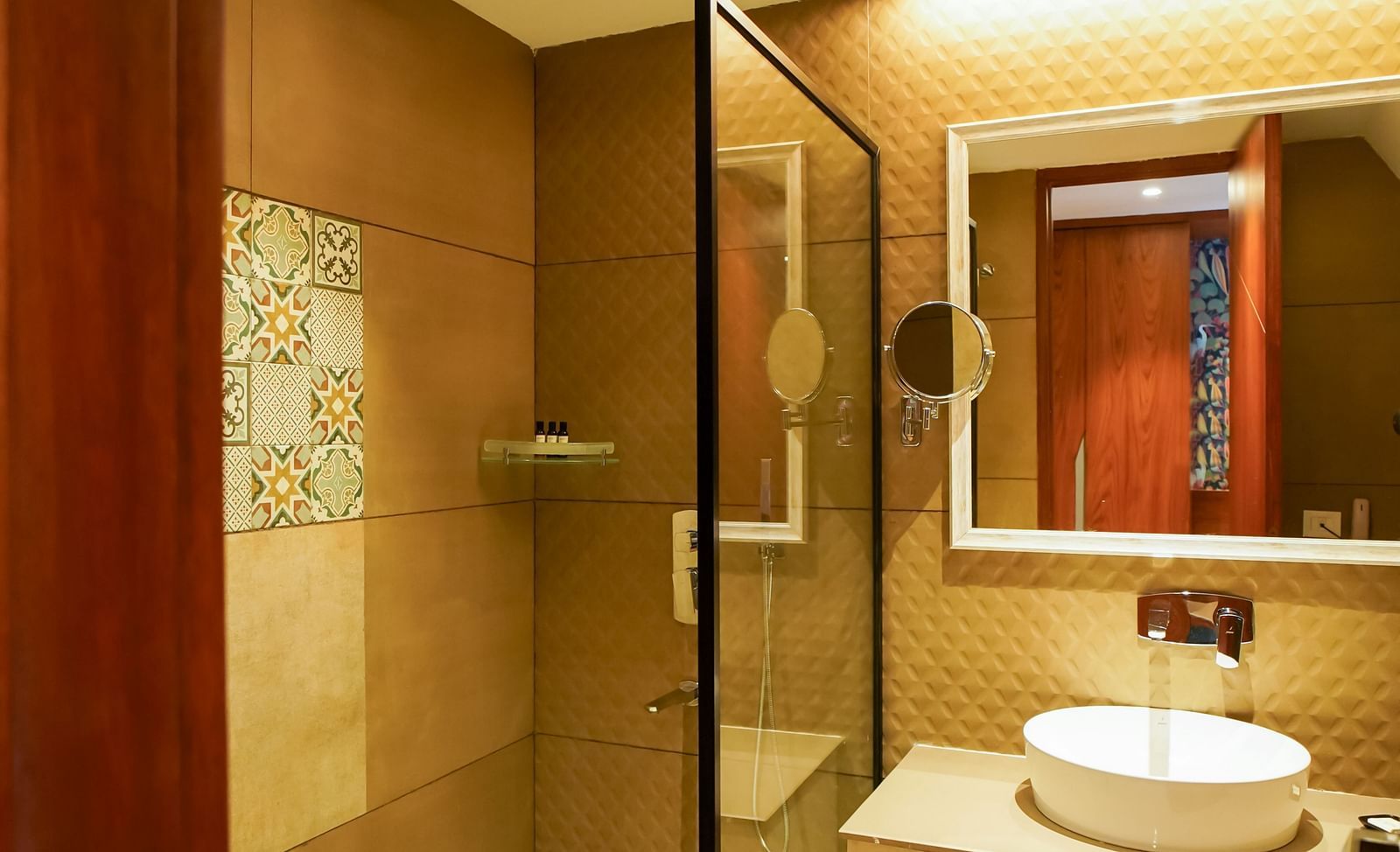A hotel room's desk area showcases a wall-mounted television above a wooden desk with a red upholstered chair | Deluxe Room with Himalayan View | Sukama Resort & Spa, Nainital