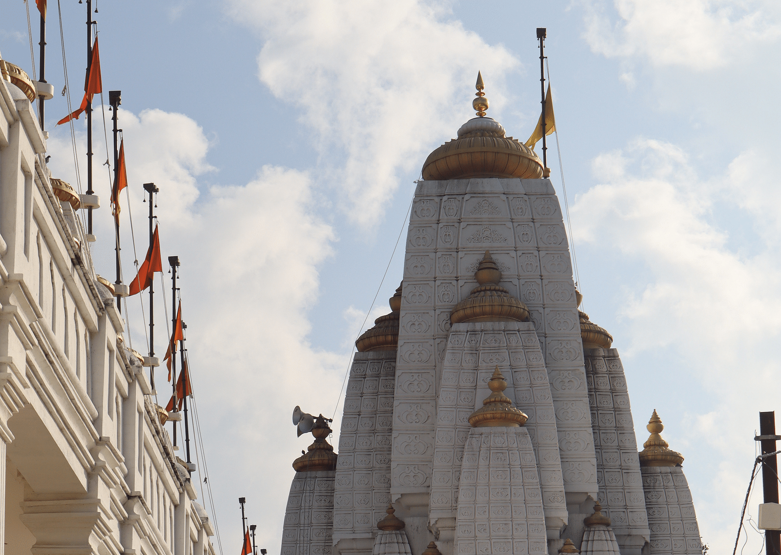 An overview of Shree Bajreshwari Mata Temple in Indore with white clouds on blue sky in the background.