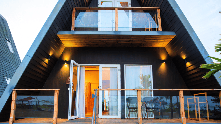 Daytime exterior view of a Duplex villa with balcony and surrounding greenery at Hotel Sonar Bangla, Taki.