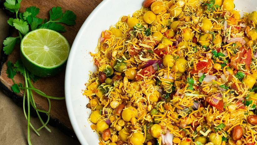 Chickpea salad topped with onions and tomatoes served in a bowl