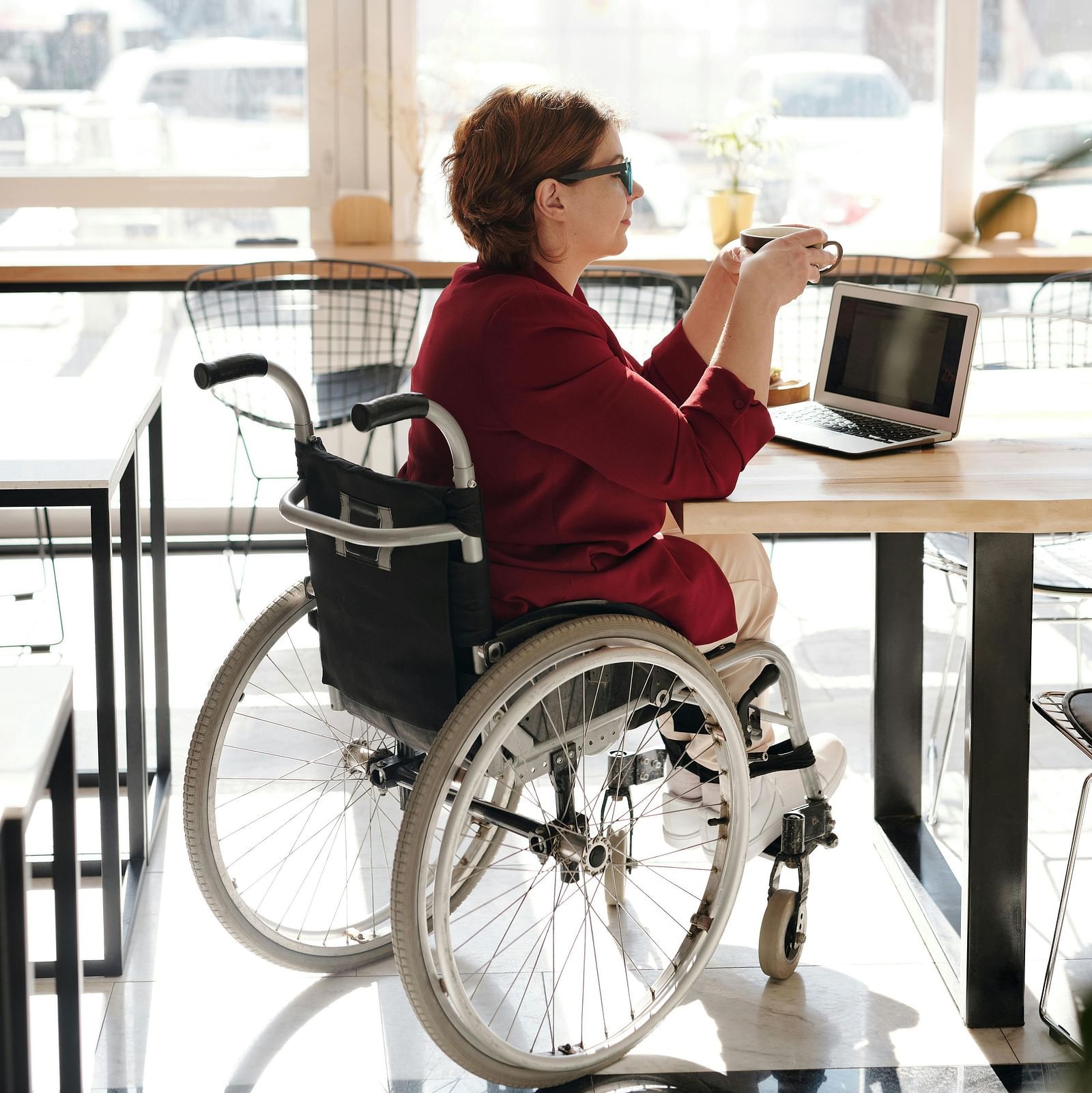  A person in a wheelchair sitting at a table