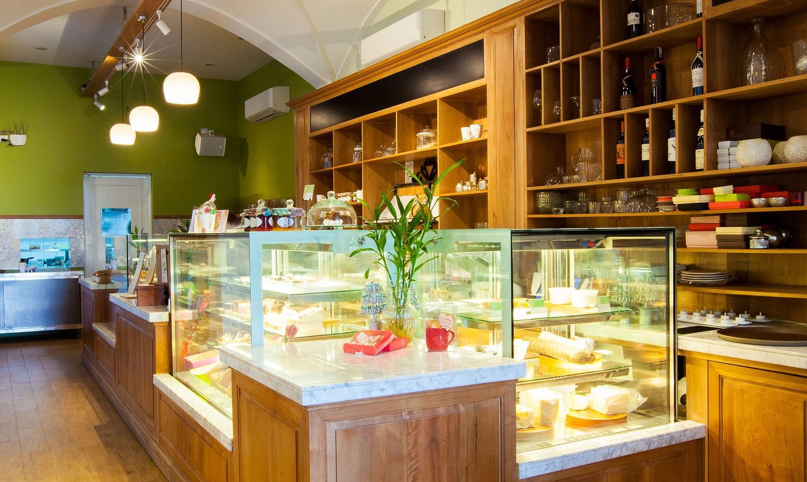 A cafe interior with a counter, display shelves, and a few tables and chairs | The Shop | Central Mansions, Phnom Penh