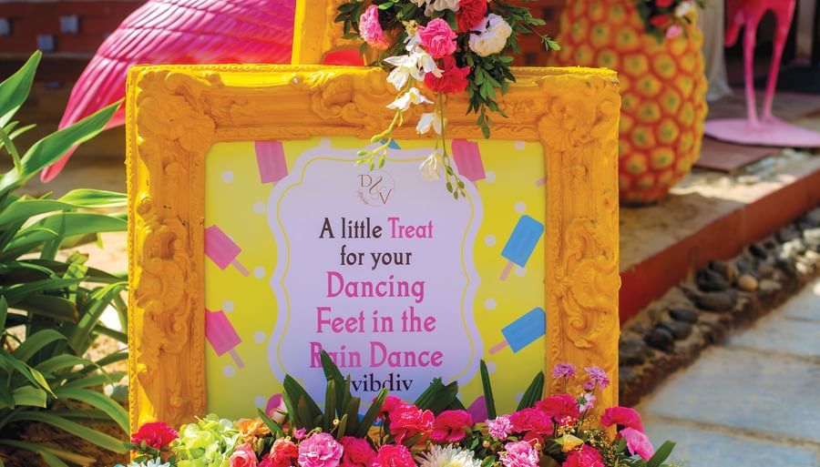 a sign post at the entrance of the wedding details - Caravela Beach Resort Goa