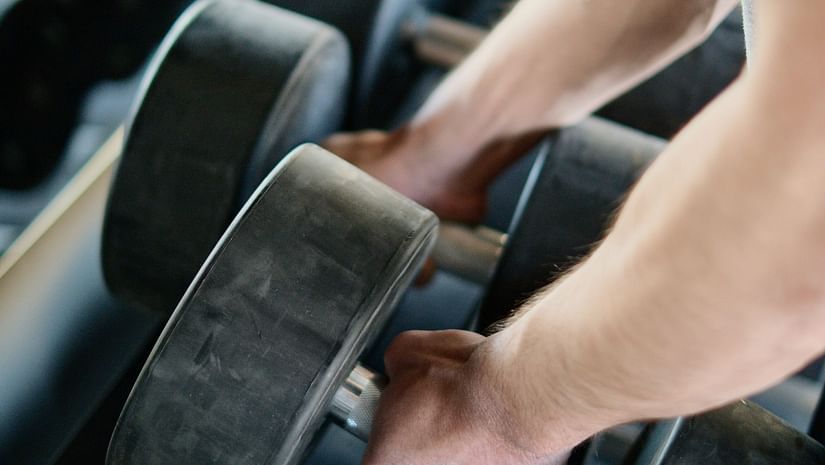 picking up weights in a gym