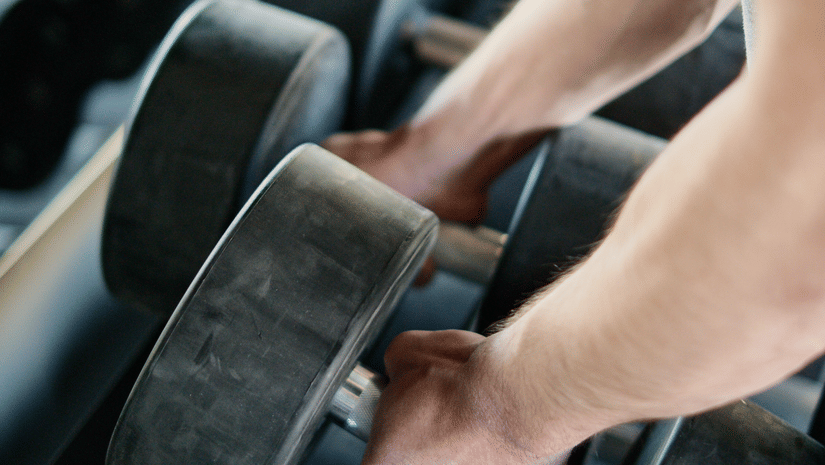 picking up weights in a gym