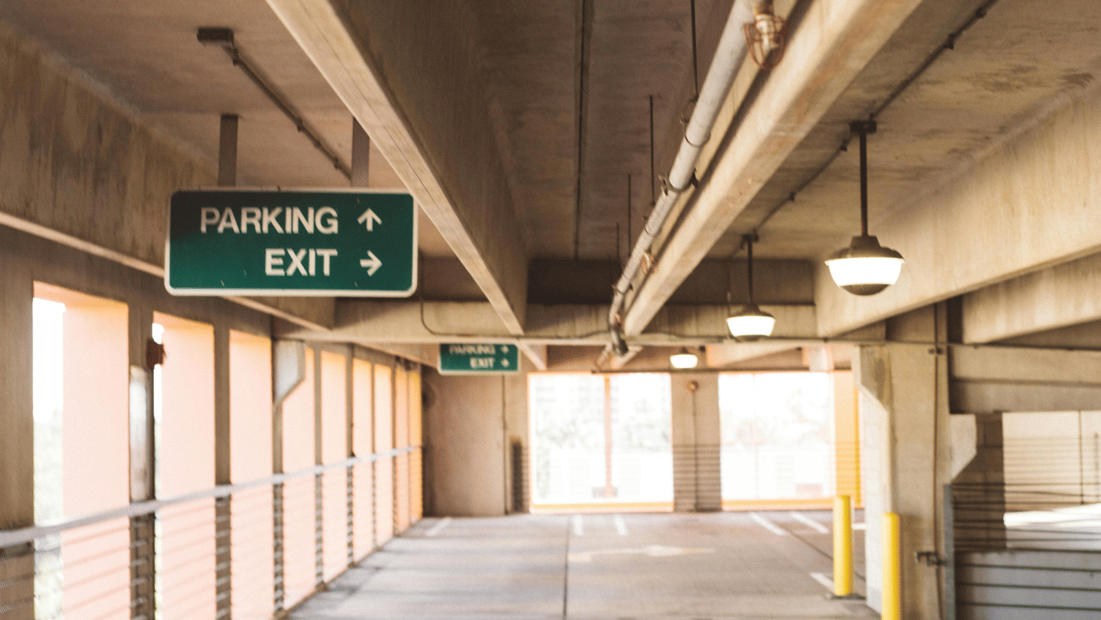 A long, empty concrete underpass or walkway with abstract lines.