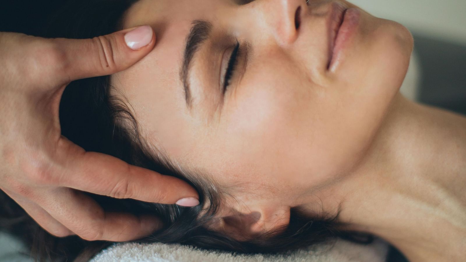 A shot of a lady receiving head massage.