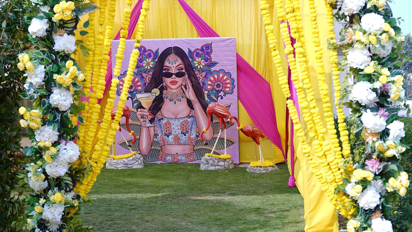 Brij Eternity, Vrindava |   A floral archway with yellow accents welcoming guests to the wedding venue.