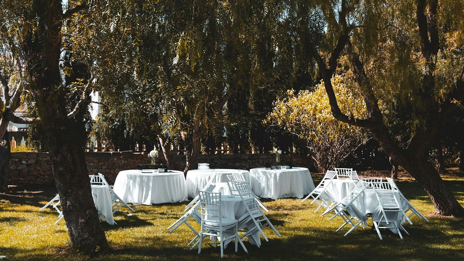 Few tables and chairs placed in a garden | Diamond Parks, Pune