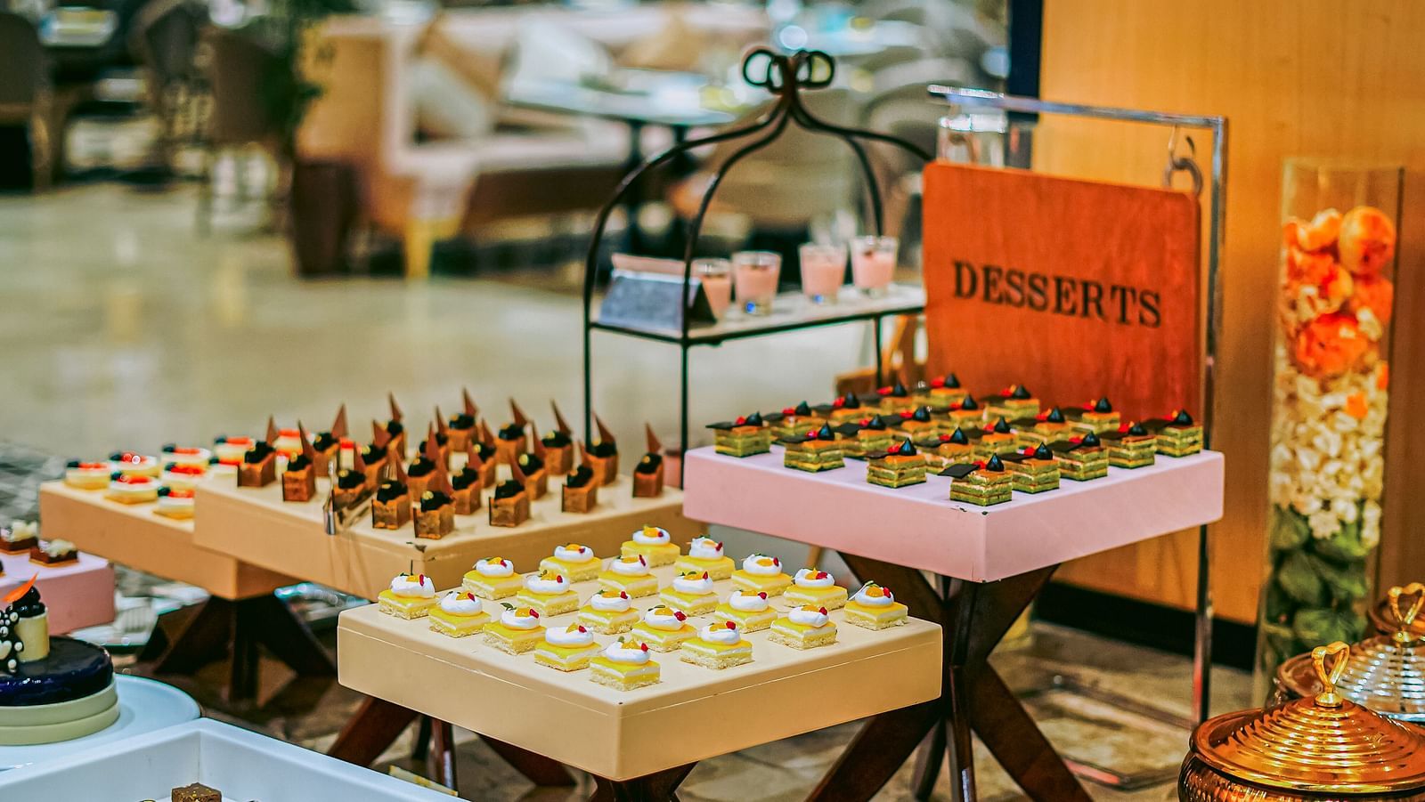 An appetising buffet spread with a variety of desserts neatly arranged on the table - Grand Madurai by GRT Hotels