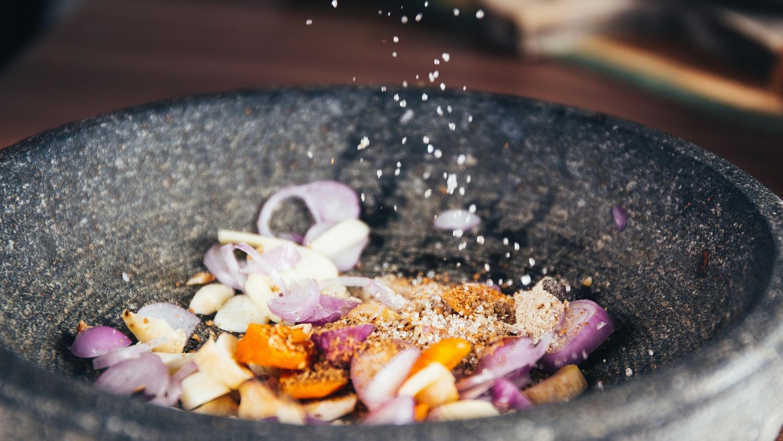 Person Pouring Salt in Bowl