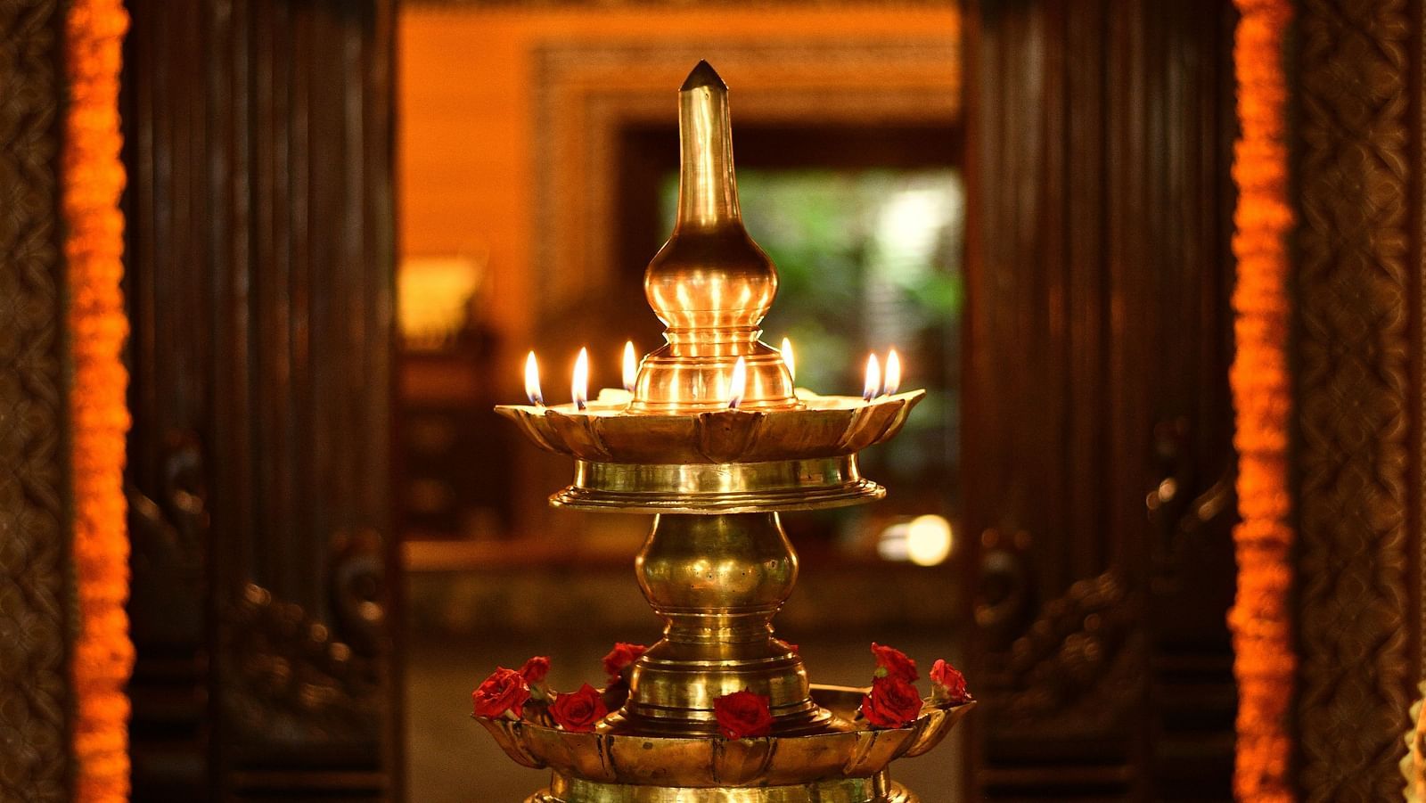 entrance with the bronze oil lamp at Hoysala Village Resort, Hassan