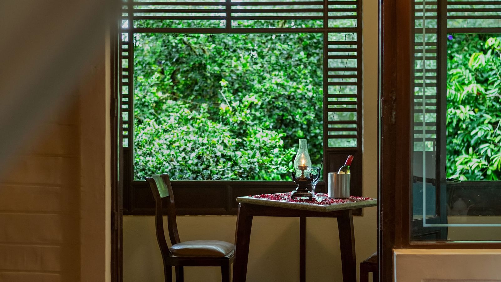An image of a room which gives a sneak peak of the outside world at Hoysala village resort, Hassan
