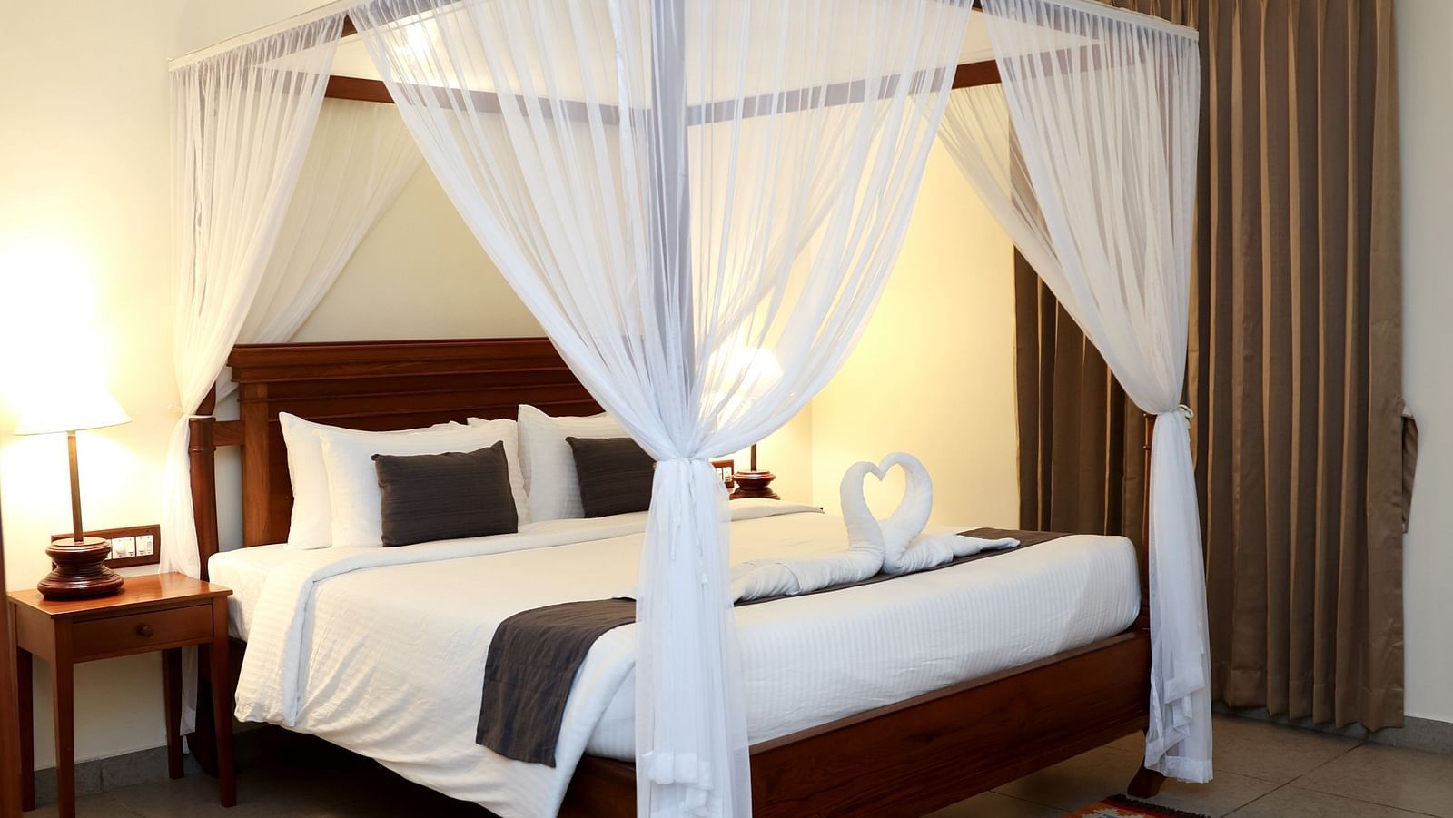 A four-poster bed beautifully decorated with fabric pieces | Mango Hill La Serene, Pondicherry