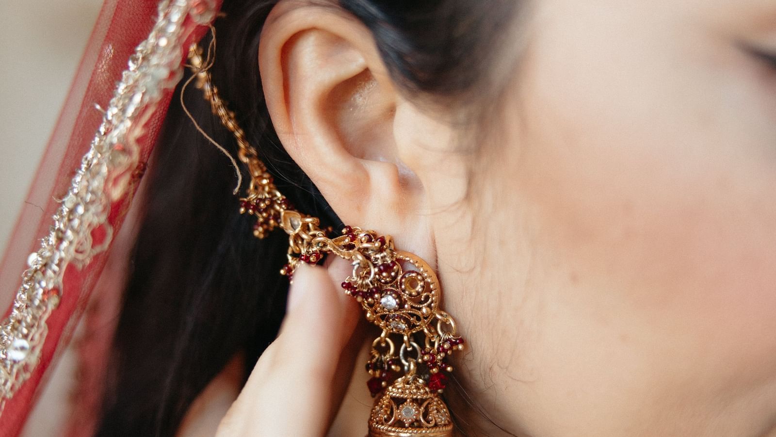 A close up shot of a  woman wearing a earring