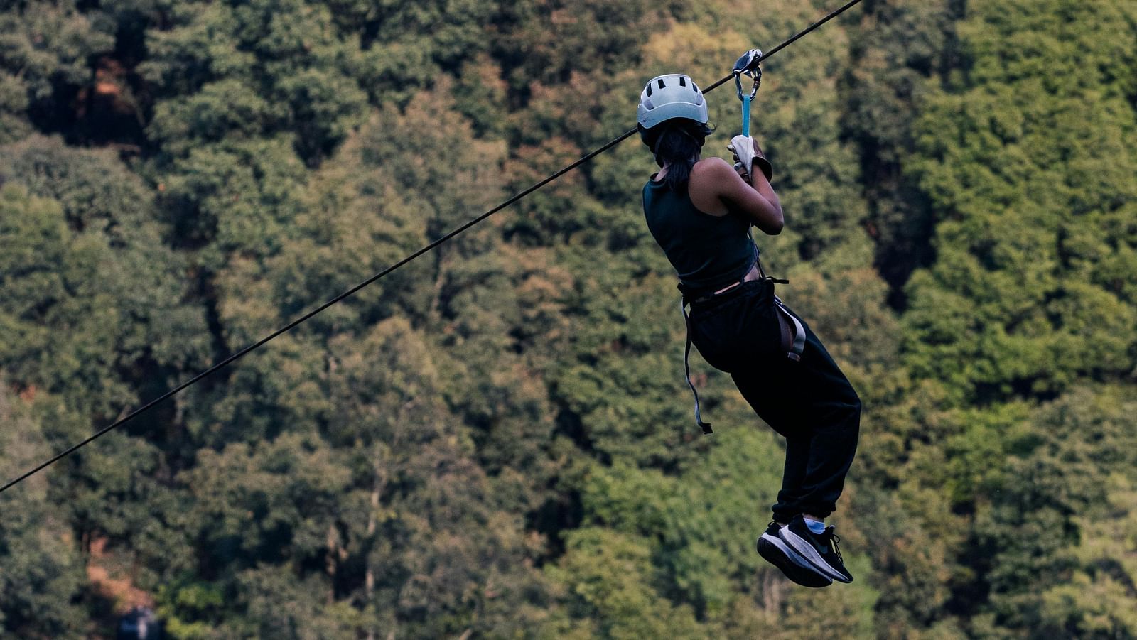 Image featuring a person doing zipline activity