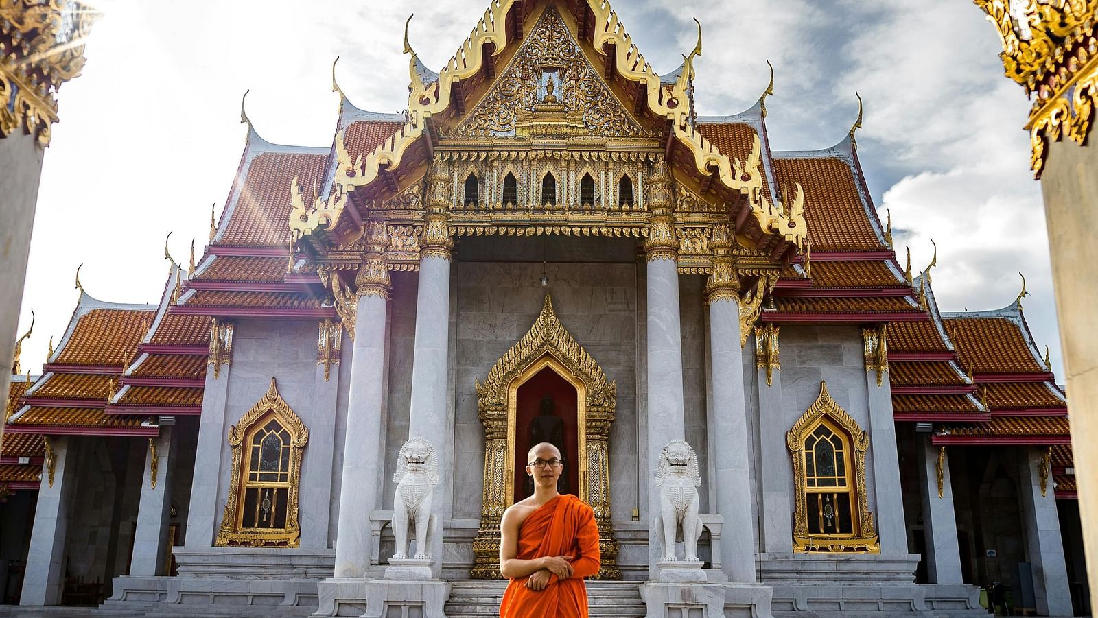 An image of a saint standing in front of the temple