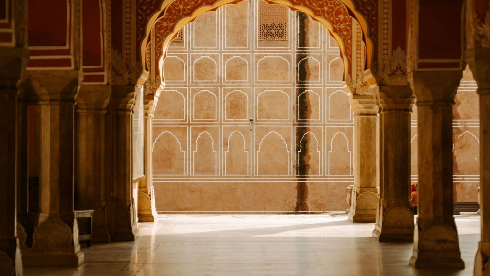 An interior view of an ancient structure showcasing arches and pillars in a traditional architectural style