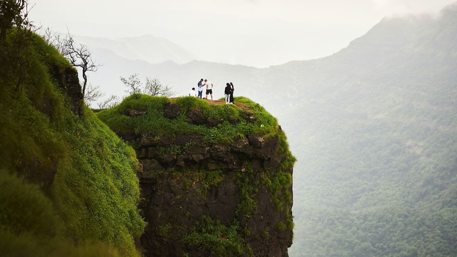 People standing on a platform that overlooks the neighbouring valleys