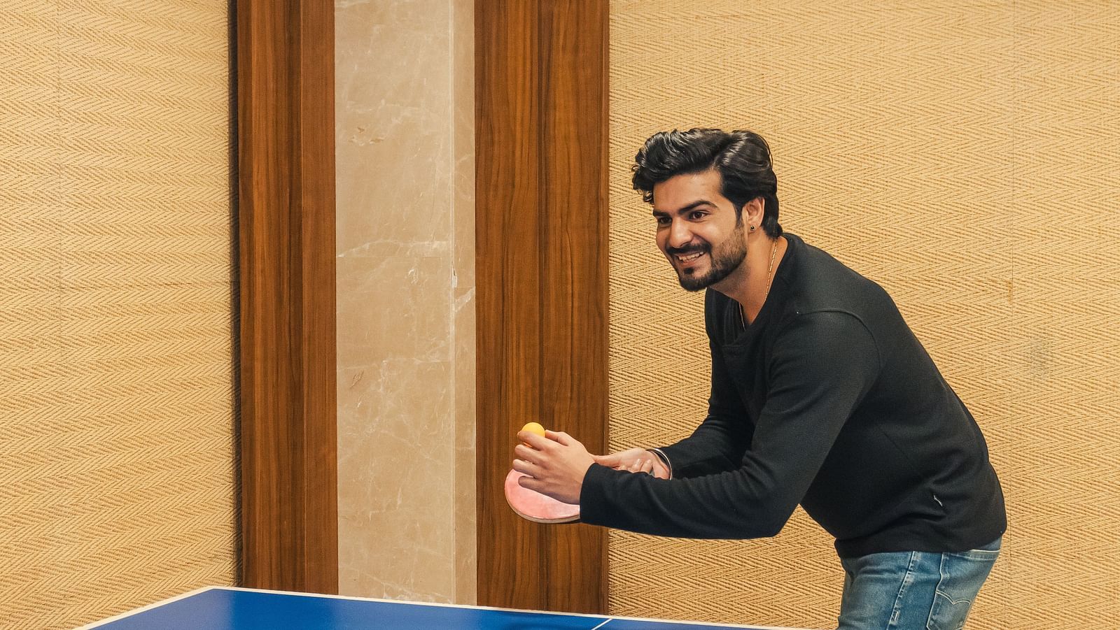  Guest playing table tennis during indoor leisure time at The Grand Legacy Resort and Spa.