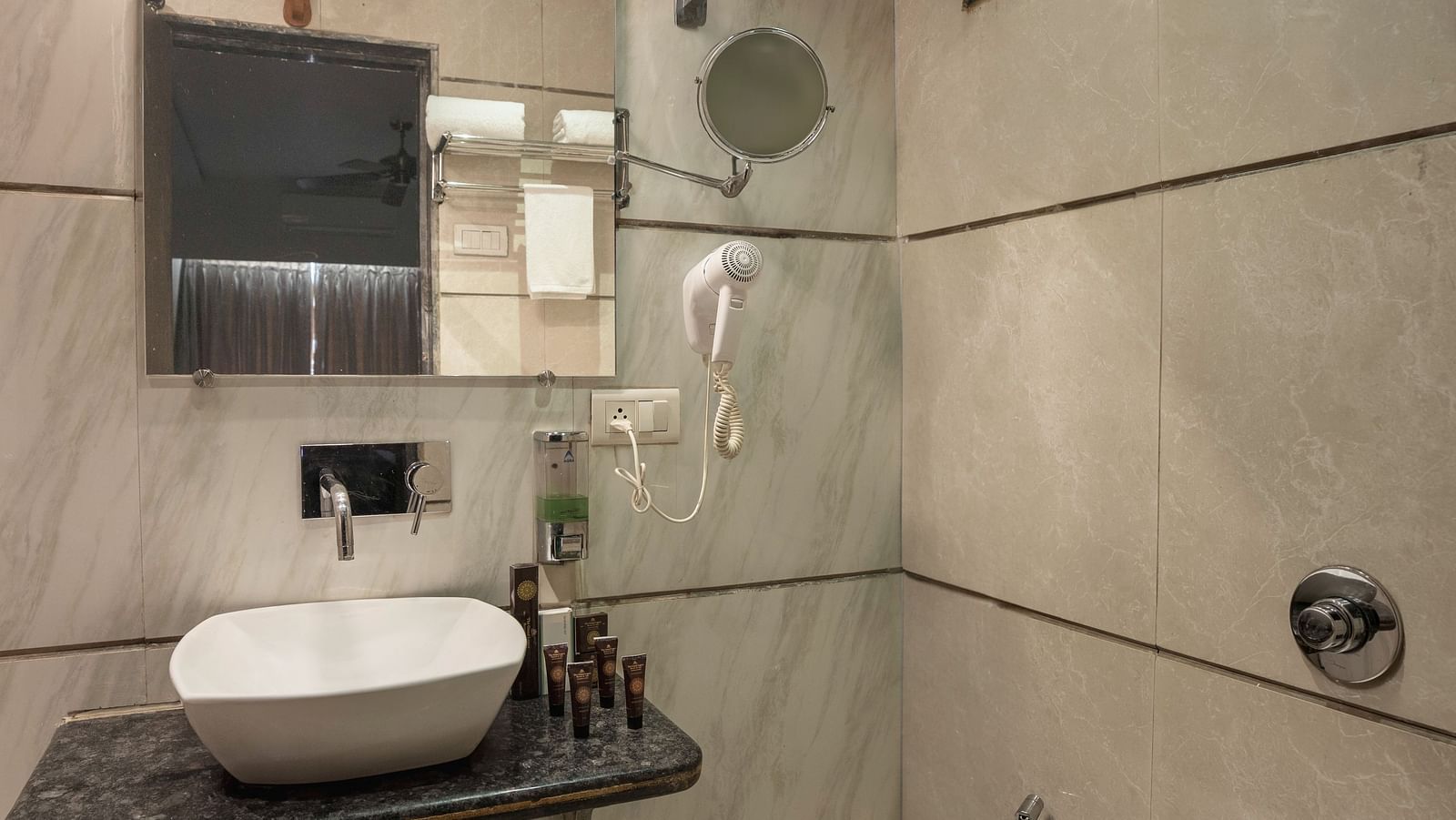 Image of a well equipped clean washroom with small mirror with other amenities | The Grand legacy Resort and Spa 