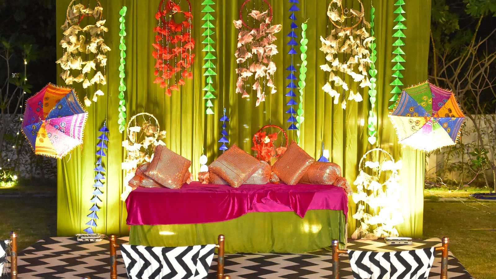 Colorful floral mandap setup for a wedding ceremony at Vedikant Hotels & Resorts with night sky in the background.