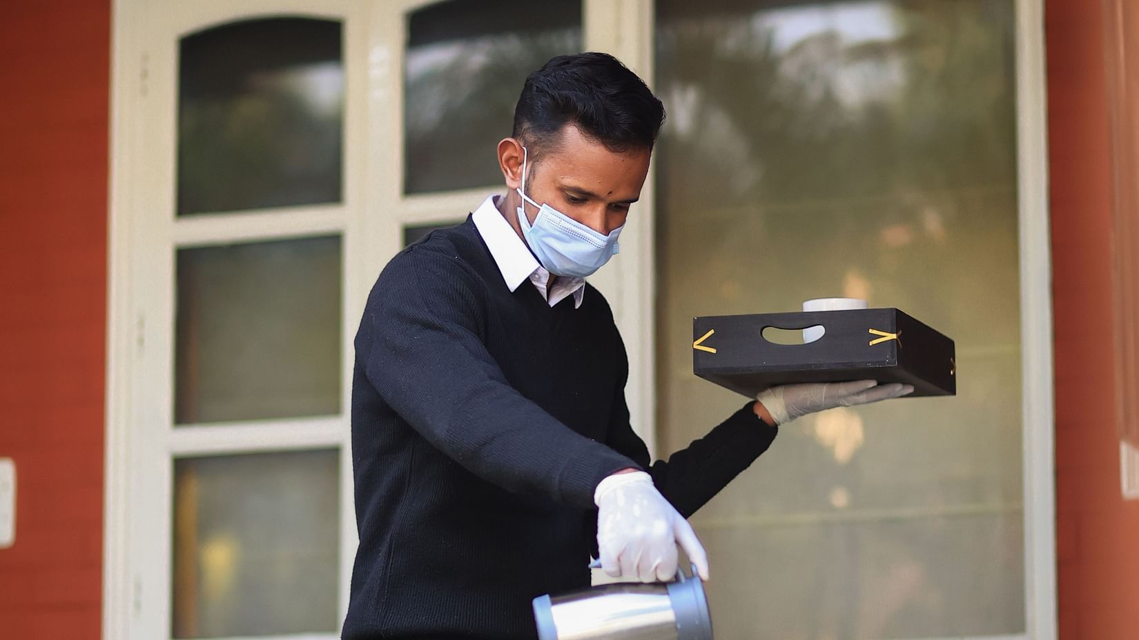 Our highly-trained staff prepping the table for tea time - Lamrin Boutique Cottages Rishikesh