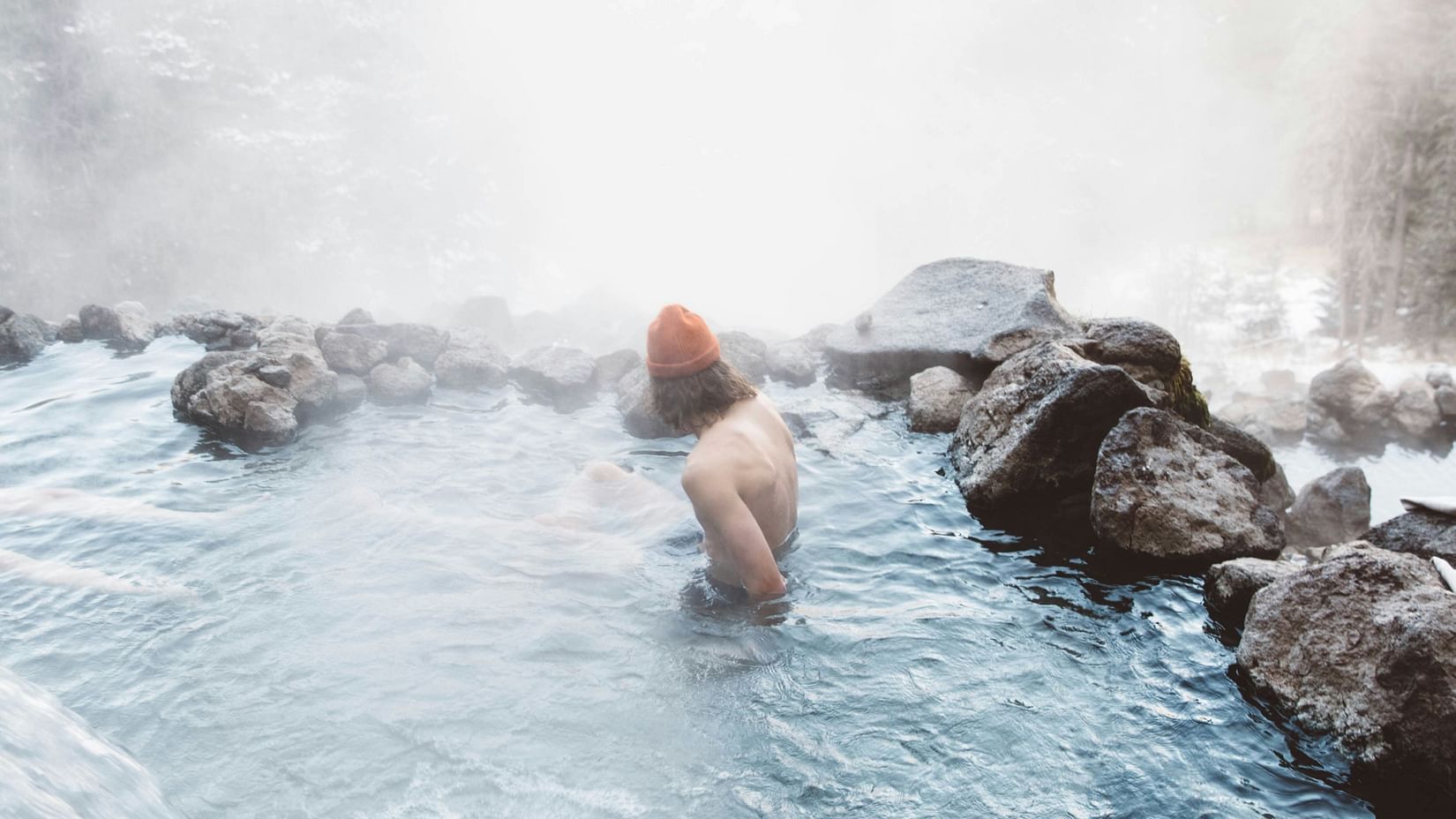 a person taking a dip in a hot spring