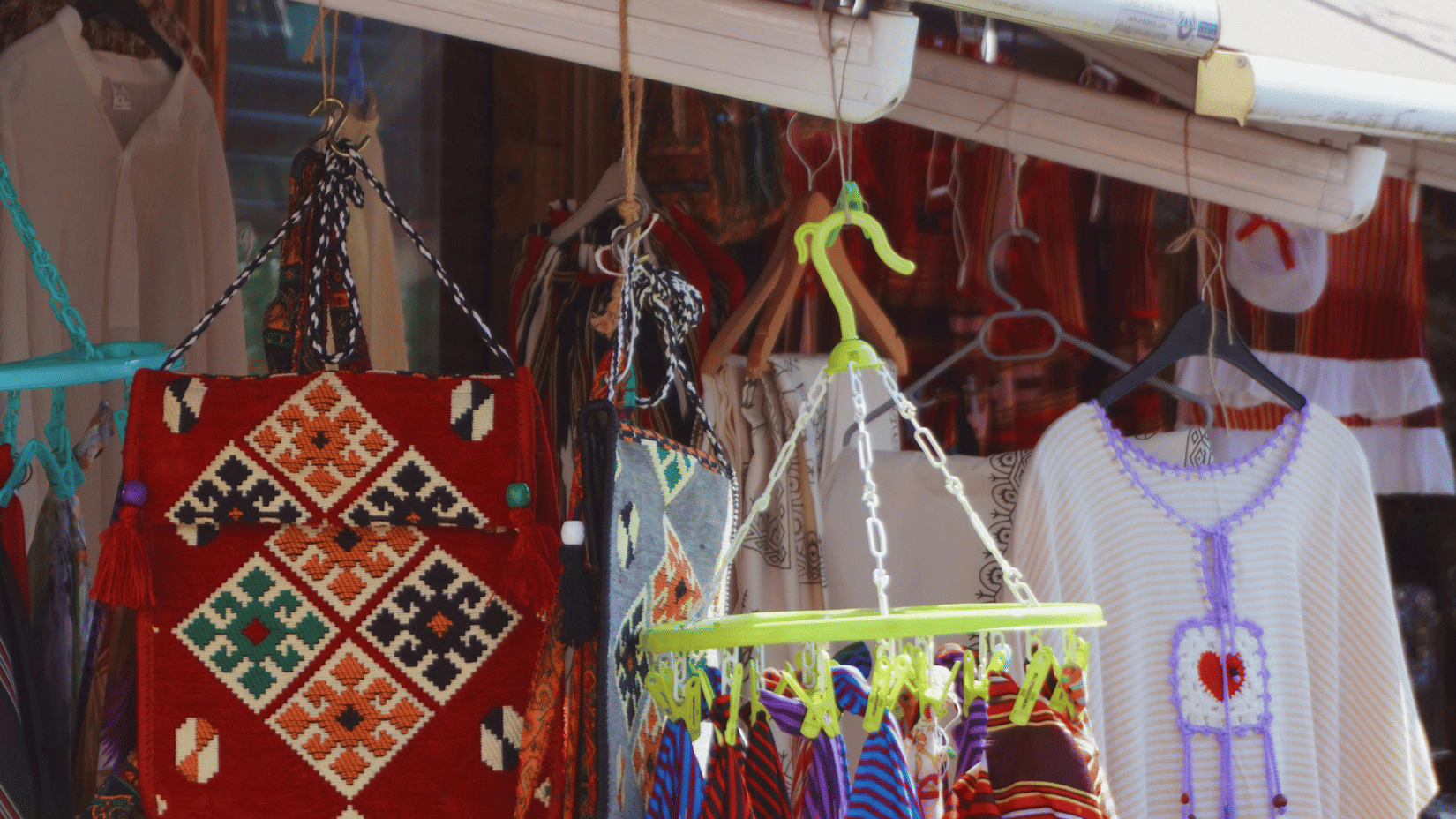 A market stall displaying colourful, handmade dreamcatchers and other items.