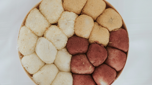 A top view of a sweet dish with many indian traditional sweets kept in it