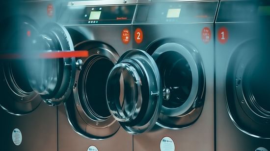 grey coloured Laundry machines with door open