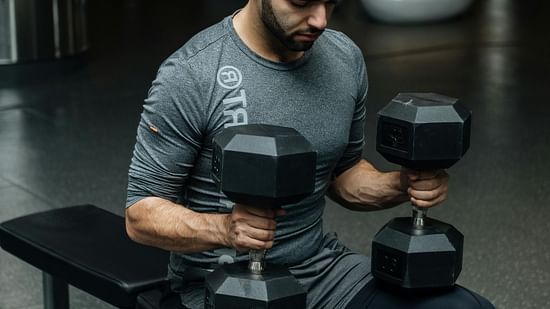 an image of a man lifting dumbbells