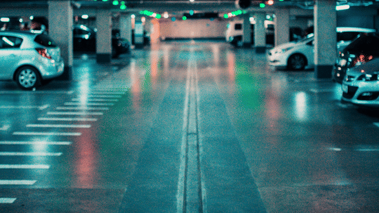 Cars parked in basement parking area with marked lanes