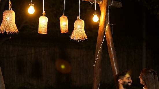 a couple enjoying candle light dinner at Themis Mudhouse - A Nature's Retreat Resort & Wellness