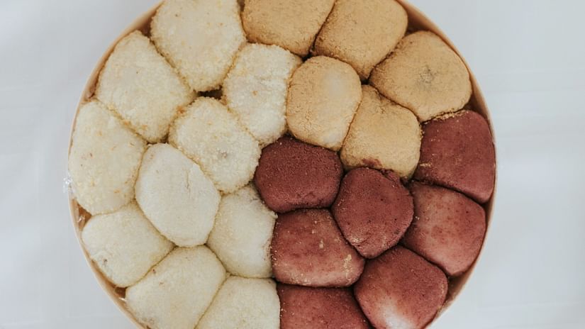 A top view of a sweet dish with many indian traditional sweets kept in it