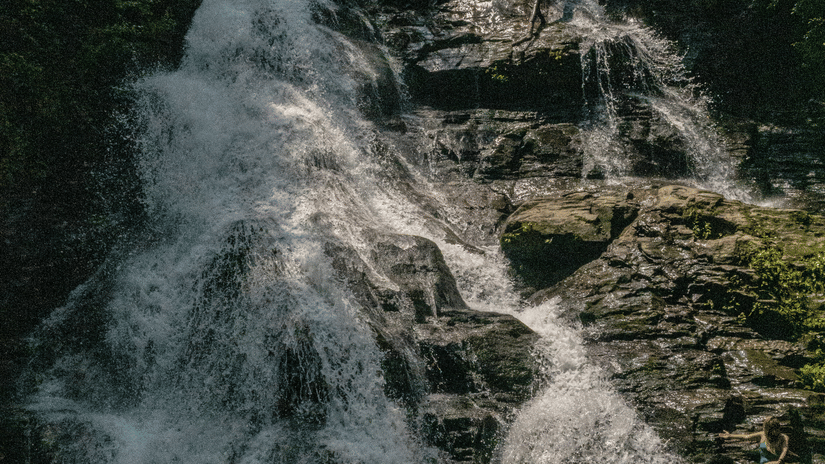 A close-up shot of a waterfall cascading down a rocky cliff.