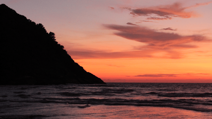 A serene sunset seen from the side of a hill