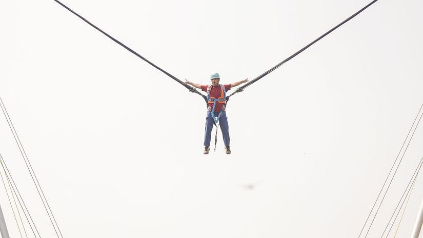 an image of an individual flying high above the ground during reverse bungee jumping at VITS Roccia Hill Resort & Adventure Park.