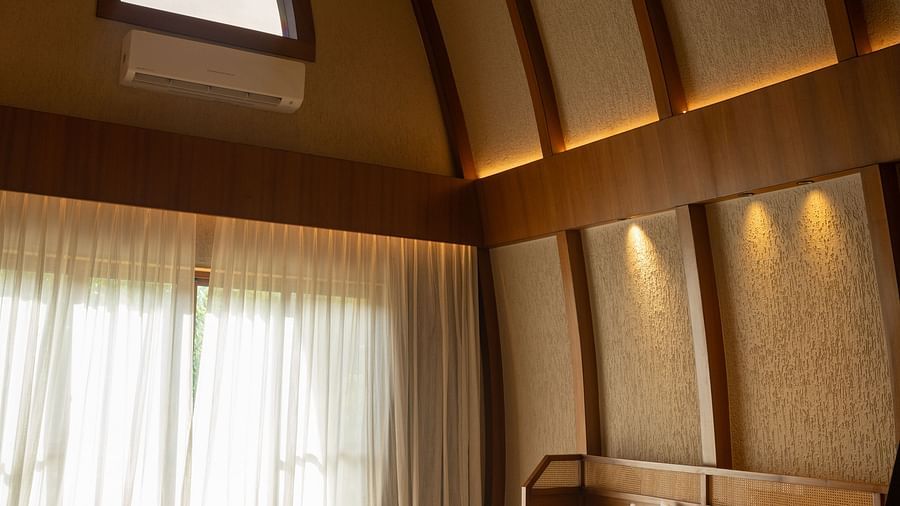 King size bedroom with high ceiling, a ceiling fan, and a seating area at Ananta Spa and Resort, Ajabgarh