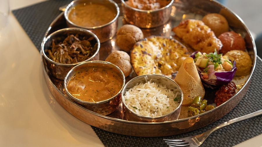 A plate of thali kept on a table at Ananta Spa and Resort, Ajjabgarh
