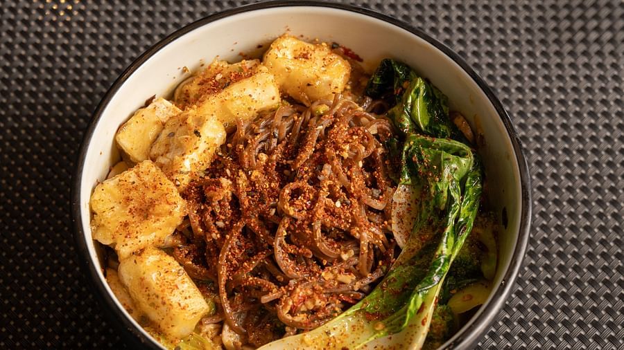 A bowl of ramen garnished with different toppings and greens at Ananta Spa and Resort, Ajabgarh