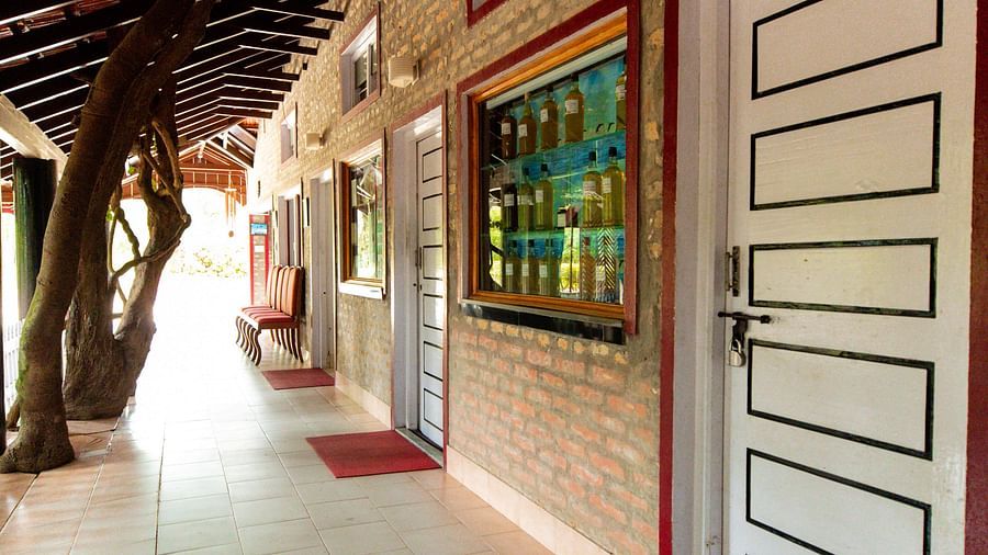An open brick wall with doors to the entrace of Capitol Village Resort Madikeri