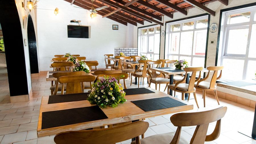 Seating arrangements at the dining area in The canopy, Capitol Village Resort, Madikeri
