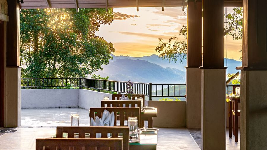 Chairs and tables in an al fresco restaurant with a mountain view | Celestial Hills, Kandy