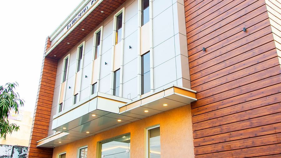 Hotel exterior with brown tiles and large window panes