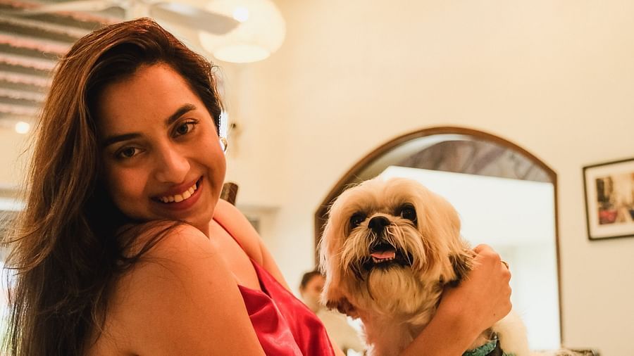a woman with a dog at our pet-friendly resort in goa