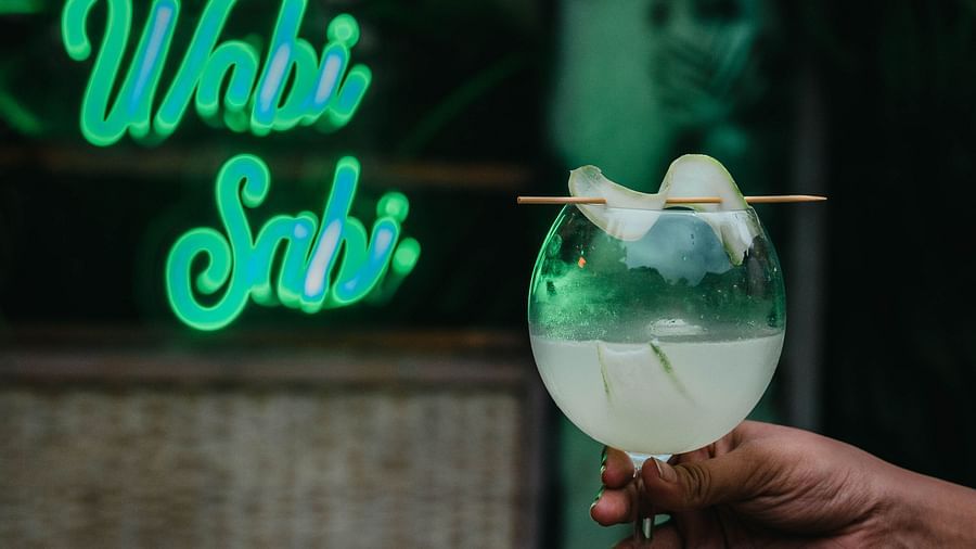 a person holding a glass of an alcoholic drink